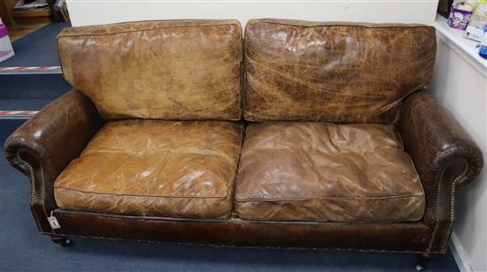 A pair of studded brown leather two seater settees W.200cm